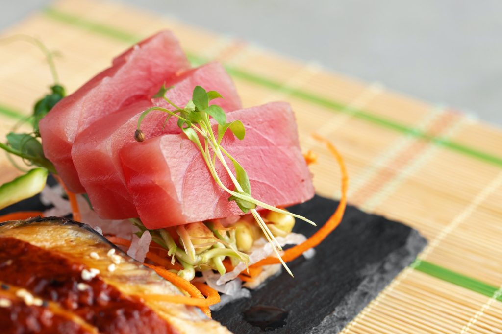 sashimi-sushi-served-on-stone-plate-close-up
